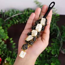 Aesthetic view of a Selenite Black Tourmaline Hanger surrounded by decorative elements