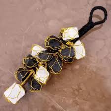 Selenite Black Tourmaline Hanger emphasizing its protective and purifying qualities